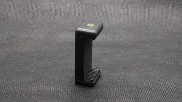Tripod U holder for smart phone and camera isolated photo