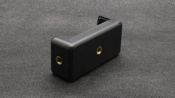 Tripod U holder for smart phone and camera isolated photo