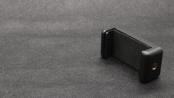 Tripod U holder for smart phone and camera isolated photo