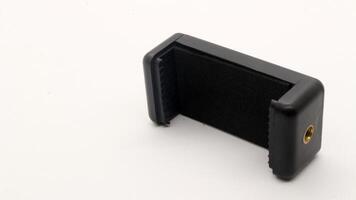Tripod U holder for smart phone and camera isolated photo