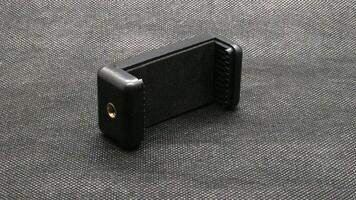 Tripod U holder for smart phone and camera isolated photo