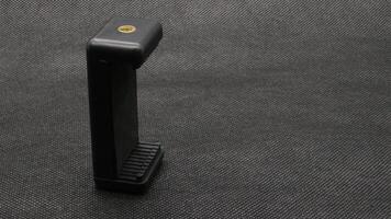 Tripod U holder for smart phone and camera isolated photo