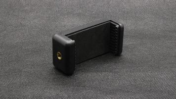 Tripod U holder for smart phone and camera isolated photo