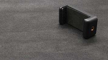 Tripod U holder for smart phone and camera isolated photo