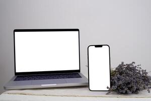 Bouquet of dry lavender Computer, laptop and smartphone, display. on white background workspace mock up design. photo