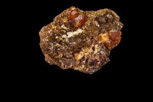 macro mineral stone Grossular, Garnet, Epidote on a black background photo