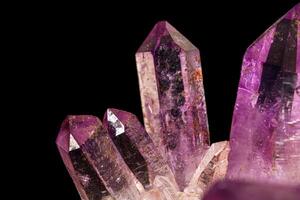 Macro of amethyst mineral stone on black background photo