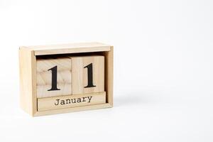 Wooden calendar January 11 on a white background photo
