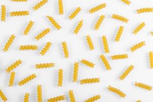 Pasta products in the form of a spiral, texture, on a white background photo