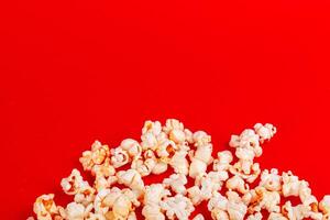 box with popcorn on a red background photo