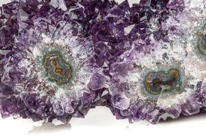 Macro mineral stone Amethyst eye, in the form of an owl on a white background photo