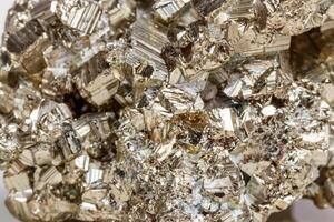 Macro mineral stone Pyrite gold on white background photo