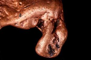Macro mineral stone of a copper nugget on a microcline on a black background photo