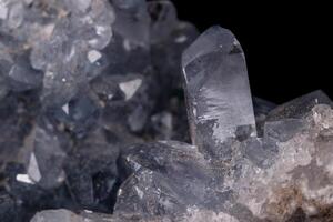 Celestine mineral stone macro on microcline on black background photo