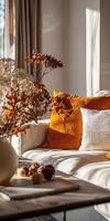 Cream Sofa With Orange Pillows and Dried Flowers photo