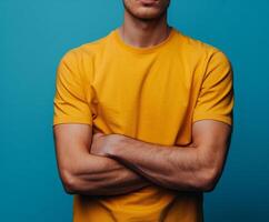 Man in Yellow T-Shirt With Arms Crossed photo