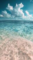 Tranquil Beach Shoreline With Clear Blue Waters and White Clouds photo