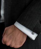 Close-up of Cufflink on Black Suit Sleeve photo
