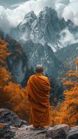 Buddhist Monk in Orange Robe on Mountain Top photo