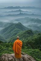 Monk Stands on Mountain Overlooking Valley photo