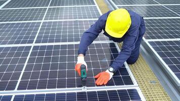 A Technician using drill installing solar cells. video