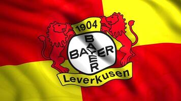 Bayer Leverkusen logo on a bright contrasting flag, seamless loop. Motion. Abstract German football club based in Leverkusen. For editorial use only. video