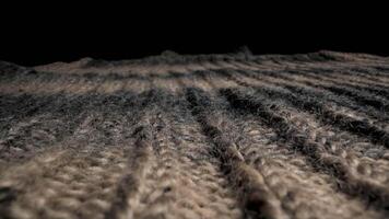 A close up view of knitted wool fabric in brown and gray. The fabric is textured and has a soft, fuzzy look. It appears to be thick and warm. video