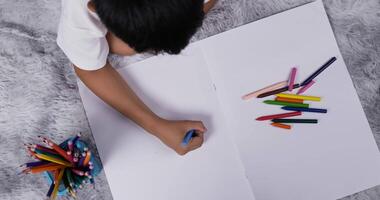 Top view of asian boy lying on warm floor with underfloor heating video