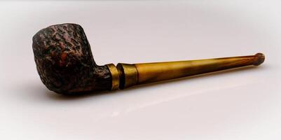 the pipe is an inlaid wooden object and is used for smoking tobacco. Here it is photographed against an isolated white background photo