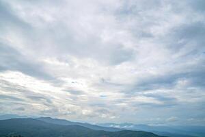 it takes time to walking up mountains which full with plants and animals. Then reach top of hills looking up to cloudy sky and panoramic views on countryside. photo