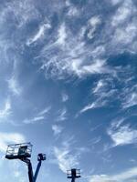Fluffy white clouds in a clear blue sky on a sunny day photo