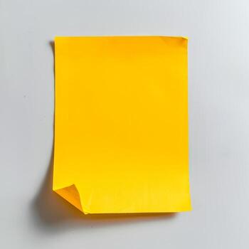 Blank yellow paper taped to the wall for writing messages. photo