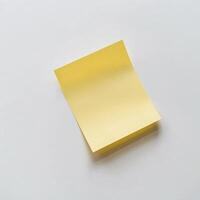 Blank yellow paper taped to the wall for writing messages. photo