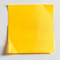 Blank yellow paper taped to the wall for writing messages. photo