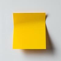 Blank yellow paper taped to the wall for writing messages. photo