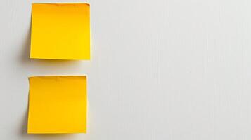 Blank yellow paper taped to the wall for writing messages. photo