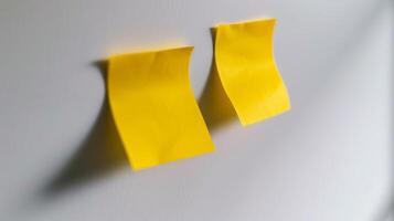 Blank yellow paper taped to the wall for writing messages. photo