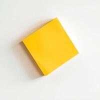 Blank yellow paper taped to the wall for writing messages. photo
