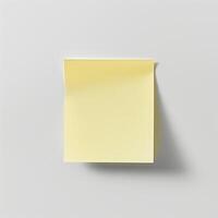 Blank yellow paper taped to the wall for writing messages. photo