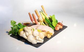 A set of the ingredients of a famous thai soup.The ingredients can be bought at the market, such as chicken vegetable and many types of herbs together combine as a great dish. photo