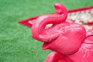 Asian Elephant statue figure sit and lay on the green turf photo