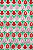 This cardigan fabric have a texture of geometric pattern with colourful red pink and green tulip flowers. photo