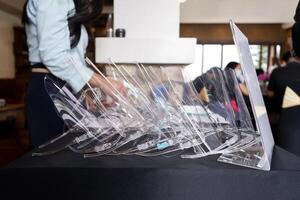 Several face shields were stacked on top of the black table, allocated to protect the staff from germs photo