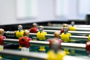football table game in which players are divided into two teams with different colors, red and yellow. photo