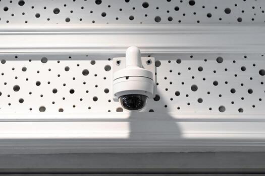 CCTV camera is installed inside the building on the ceiling and wall for monitoring and running safety system control in that area. photo