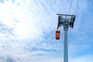 red cable car are floating on a sling for transportation by visitors and travelers who came this Theme Park and look around for environment above high view. photo