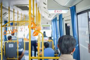 Exit sign light box is hung on the ceiling inside the bus, Thailand. photo