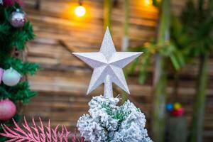 Christmas Tree with snowflake is decored with ball, presents and gift in pink theme for Christmas and new year event photo