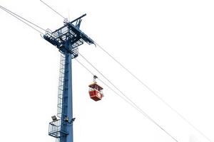 red cable car are floating on a sling for transportation by visitors and travelers who came this Theme Park and look around for environment above high view. photo