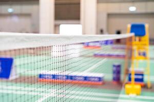 badminton net Close up shot of a used in court with blurred background in sports stadium. photo